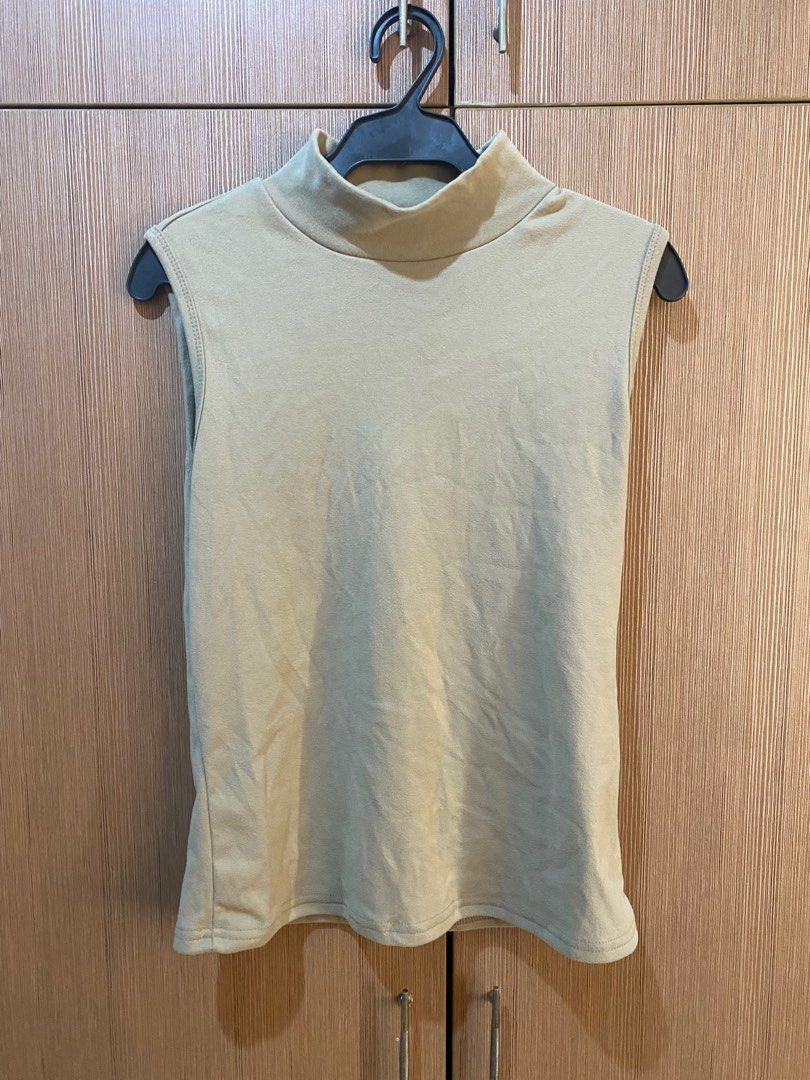 Sleeveless Cream Turtleneck (Category: Sleeveless) located in Quezon City. Submitted by bmswardrobe (Listing ID 1362705838, Image 1). Description: slightly nego l: 60cm bust: 84cm waist: 79cm shoulder: 35cm.
