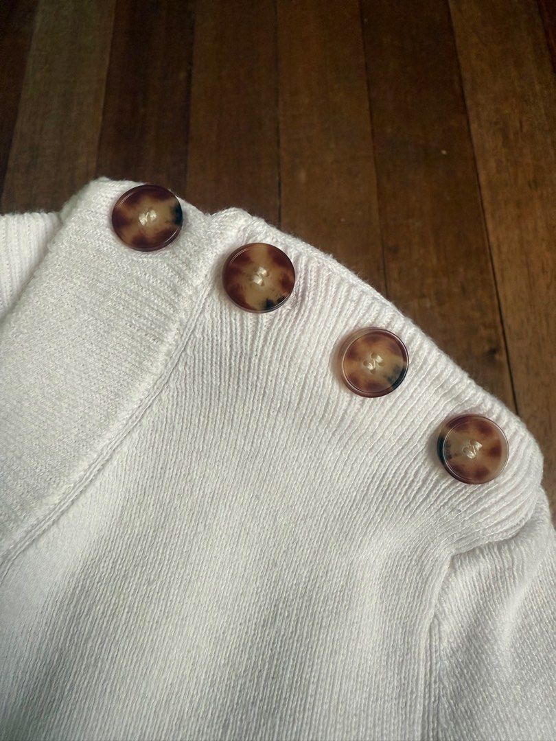 Stripped Half-Sleeve Knitted Top (Category: Blouses) located in Quezon City. Submitted by corncarts (Listing ID 1362738381, Image 2). Description: Off-white + black striped top Knitted material (cotton + polyamide) Very stretchy (M on tag, but fits up to XL) Tortoiseshell button detail on one shoulder (working buttons) tags: old money, dark academia.