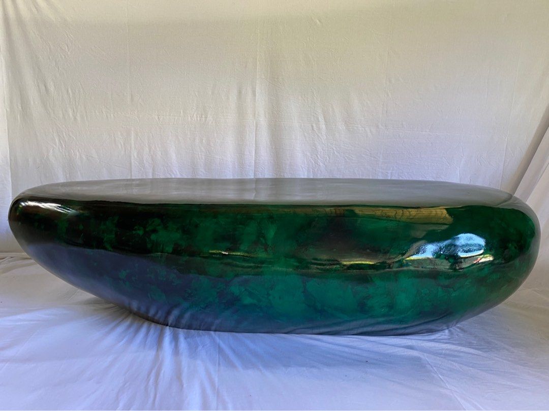Epoxy bench/table hand painted. 200cm long (Category: Other Home Furniture) located in Makati City. Submitted by olxph_299450477 (Listing ID 1366700870, Image 1). Description: This green pebble shaped stone measures 200cm long and has a height of 45cm and can be used in as well as outdoors. This piece can be used as a bench or a center table. It is made of 6 layers of epoxy which are individually painted with transparent green shades and black to