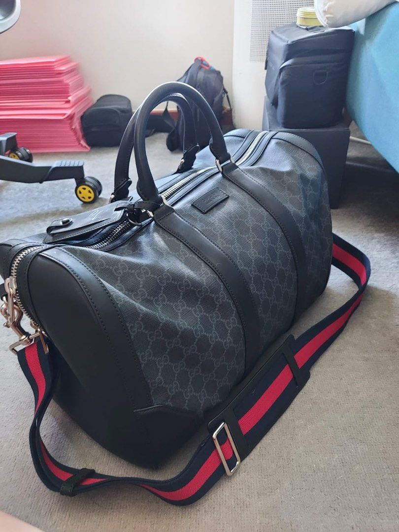 GUCCI leather travel duffle bag lightly used (Category: Bags & Wallets) located in Singapore. Submitted by bellababe (Listing ID 1366610356, Image 1). Description: GG Black Carry-On Duffle Bought from London around SG$3,590 in 2019. Selling it as I have another go to carry on duffle; used less than 5 times :) Incredibly malleable, this large duffle is made in soft GG Supreme, crafted from a coached microfibre fabric with the GG motif. Coms with a