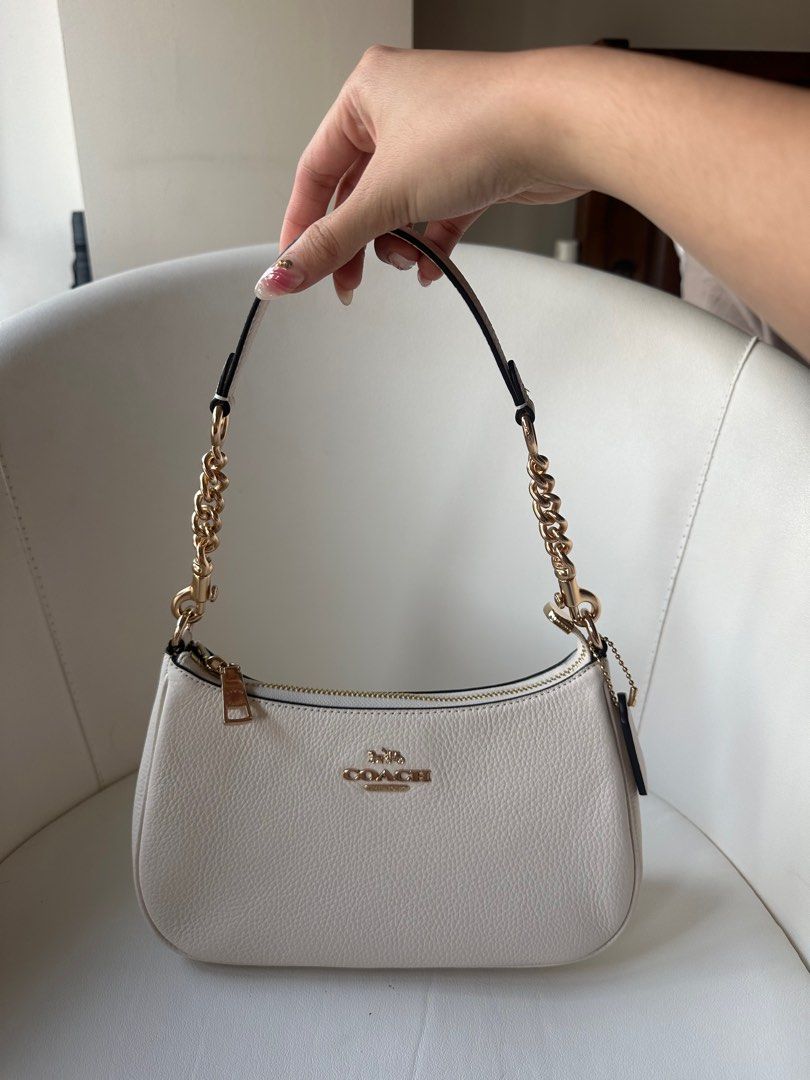 Coach Teri Shoulder Bag in White (Category: Luxury Bags & Wallets) located in Manila. Submitted by nicolebhans (Listing ID 1368310815, Image 2). Description: • Authentic with Tags and Dust Bag • Bought in Japan (with authentication card) • Brand New • Retails for Php 19k based from coach website (can send link) Php 15k (LAST PRICE) RFS: Too many white bags Can meet up or do deliver 👇🏻 Delivery: Grab, lalamove, j&t Meet up: Glorietta or Greenbel