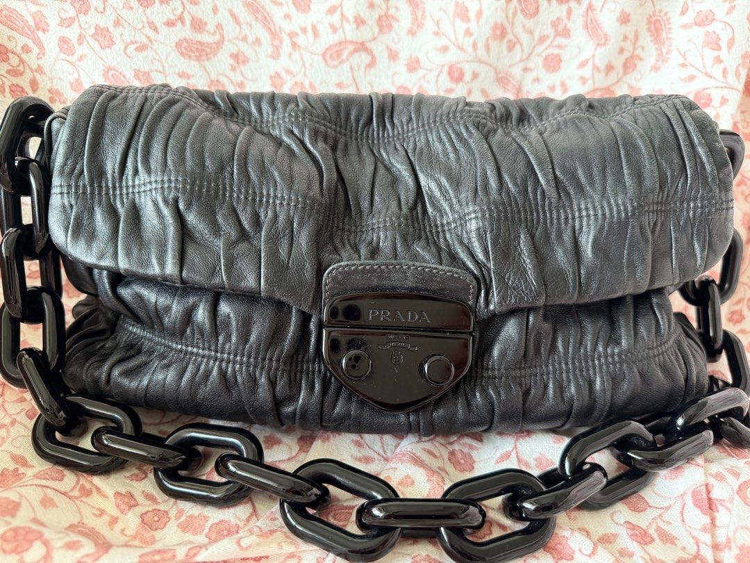 Prada nappa gaufre flap bag - vintage *authentic* (Category: Bags & Wallets) located in Singapore. Submitted by meow10 (Listing ID 1368229186, Image 1). Description: Reduced to clear. Bag alone. No torn or tear. Well used. Not for fussy. Authenticity guaranteed else full refund. Arrange self pick up.