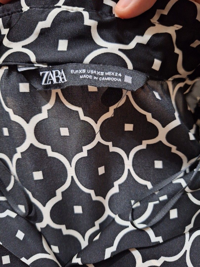 ZARA satin printed shirt (Category: Shirts) located in Makati City. Submitted by worn2work_treasures (Listing ID 1368297896, Image 2). Description: Length - 27 inches Width -19 inches Shoulder to shoulder width - 16inches Arms - 7 inches Please note that sizes for Zara varies depending on the country where it was made. I noticed that in the other printed shirt, it was Small for Turkey but for made in Cambodia shirt, its XS. Also the Square symbol