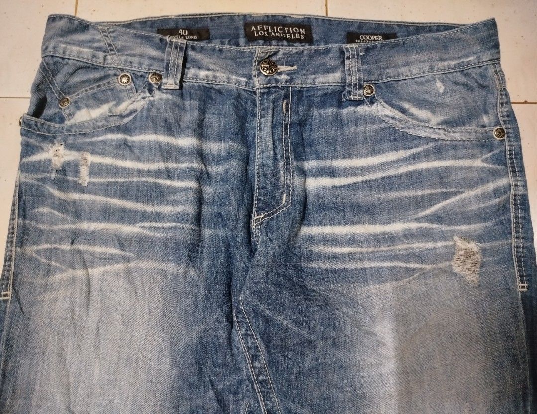 Affliction Blue Jeans (Category: Jeans) located in San Juan City. Submitted by reddvelasquez4298 (Listing ID 1368446452, Image 3). Description: Affliction Blue Jeans Cooper Relaxed Boot Distressed Size 40-41 Waistline 46.5 Length Thigh 11 Leg Opening 10.5 Good Condition May washable stains, check photos. 😊 1750 pesos PM.