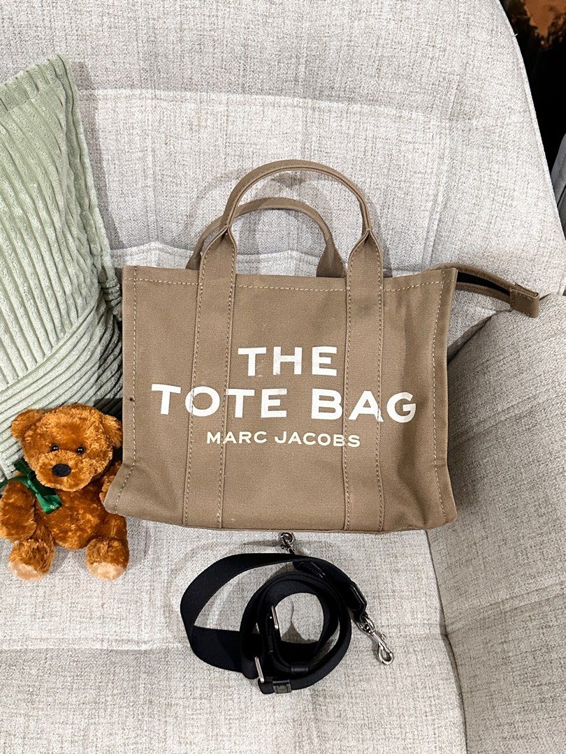 Marc Jacobs The Tote Bag Medium Canvas with shoulder strap Preloved Authentic (Category: Luxury Bags & Wallets) located in Manila. Submitted by luvforbagz (Listing ID 1368714425, Image 1). Description: 💯 Authentic with Marc Jacobs care card Army Green Well used, strap almost new made in vietnam only issue is the zipper puller dont have the small piece of cloth on it. this doesnt impact the functionality of the bag plus sf.