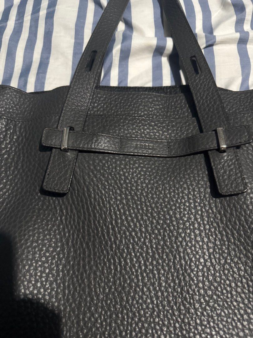 Furla Giove Tote (Category: Luxury Bags & Wallets) located in Mandaluyong City. Submitted by ericrn (Listing ID 1368786912, Image 3). Description: With small rubs at the bottom part. Please see the last 2 pictures. [Specifications] Open closure 1 outer pocket (open type) 5 inner pockets (zipper type, open type) 1 pen stab 1 D-ring [Material] Calfskin [Color name] NERO [Hardware] Silver [Size] Length 35.5cm x width 38cm x gusset 14cm Handle: 40.4c