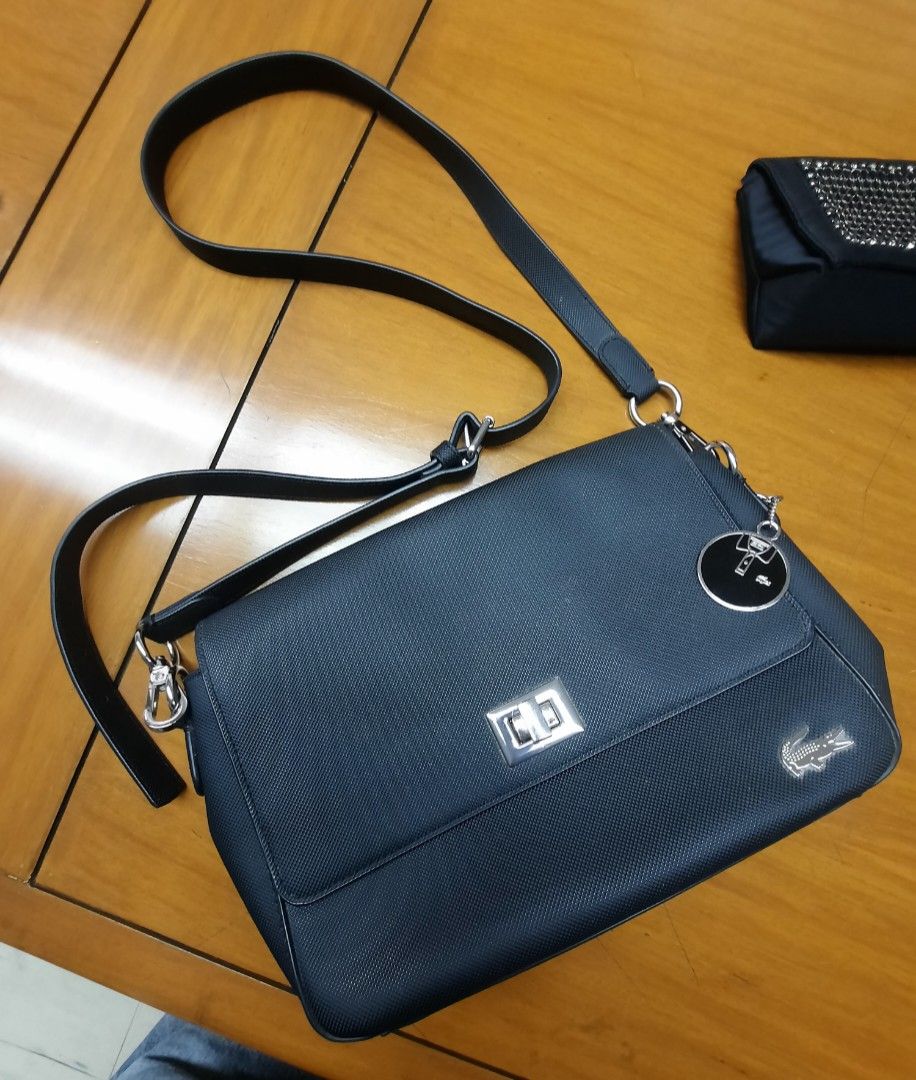 [ 💯 authentic] Lacoste Flap Cross-body Bag black (Category: Cross-body Bags) located in Las Pinas. Submitted by lbays_mint (Listing ID 1345948768, Image 1). Description: get yours, preloved item Lacoste Cross-body flap bag 🎒 Bought in local Lacoste stores 💯 authentic ..condition 9/10👍 with key chain plus dust bag size: 27 x 19cm.