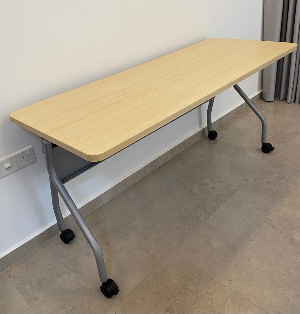 Foldable study table with lockable wheels (Category: Tables & Sets) located in Singapore. Submitted by shepc (Listing ID 1369025554, Image 1). Description: Nice and pleasant looking. Solid and heavy table. Yet comes with lockable wheels, so it can be moved easily and lock when stationary. Also it is safe due to its round edges. Dimension: 150cm (W) x 60cm (D) x 74.5cm (H) Folded dimension: Dimension: 150cm (W) x 45 (D) x 115cm (H) Selling because