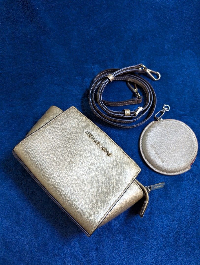 Michael Kors Selma Mini (Category: Cross-body Bags) located in Quezon City. Submitted by declutterwithstar (Listing ID 1369147099, Image 1). Description: MK Selma Mini Sling Bag ➡️PRELOVED Color: Gold ✅onhand in Quezon City MOP: Gcash, Maya, Bank Transfers MOD: Lalamove, Grab, Flash Express.