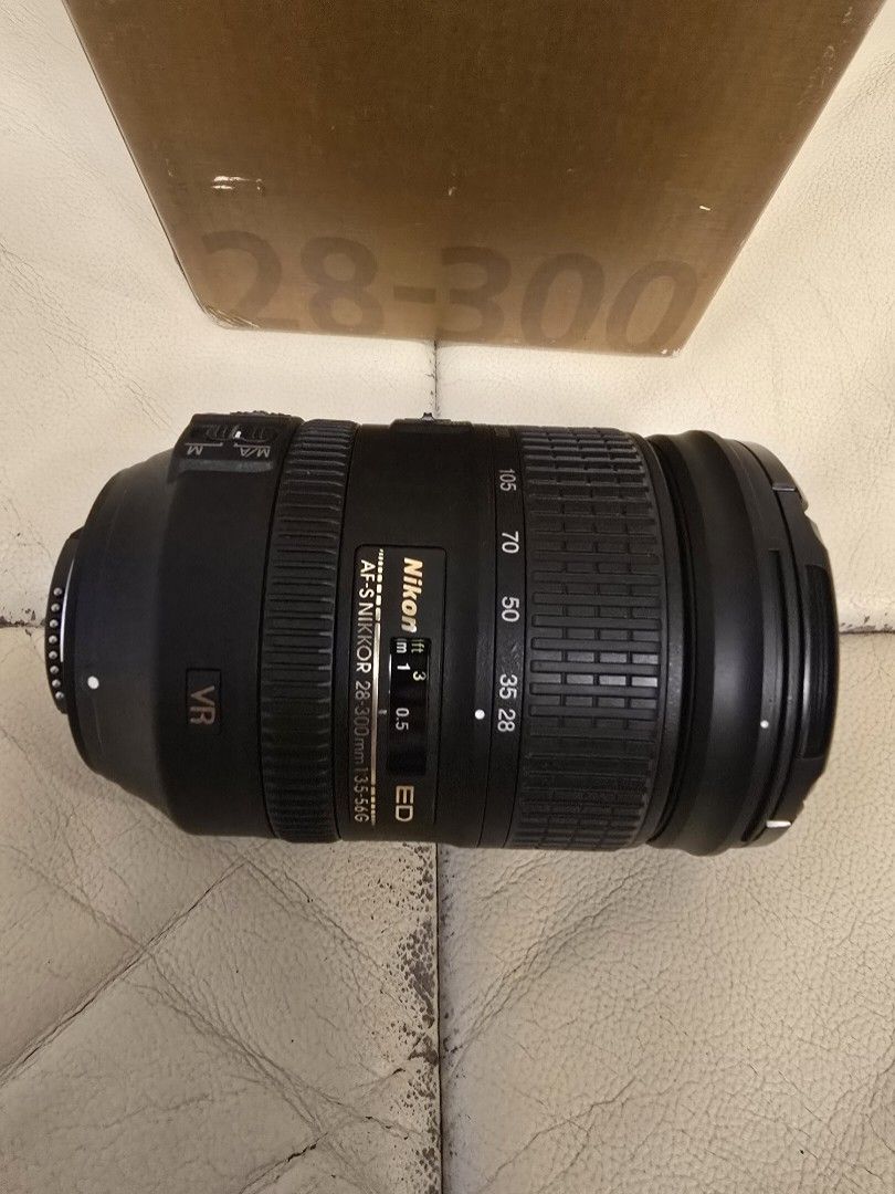 Nikon 28-300 mm camera lens (Category: Lens & Kits) located in Makati City. Submitted by nelsonl4 (Listing ID 1368524302, Image 2). Description: This lens is valued for its versatile 10.7x zoom range, vibration reduction, and suitability for FX-format Nikon cameras, making it popular for travel and general photography. AF-S Nikon 28-300mm VR Lens.