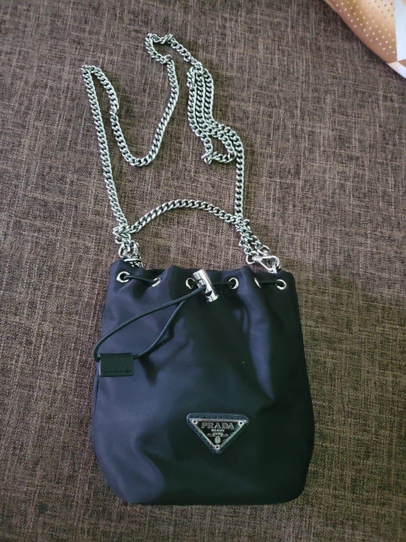 Authentic Prada Nylon Bucket (Category: Luxury Bags & Wallets) located in Las Pinas. Submitted by collextingluxuries2889 (Listing ID 1369580382, Image 1). Description: Authentic Prada Nylon Bucket comes with silver long chain No flaws. No issue. Comes with dustbag only RFS: Declutter .
