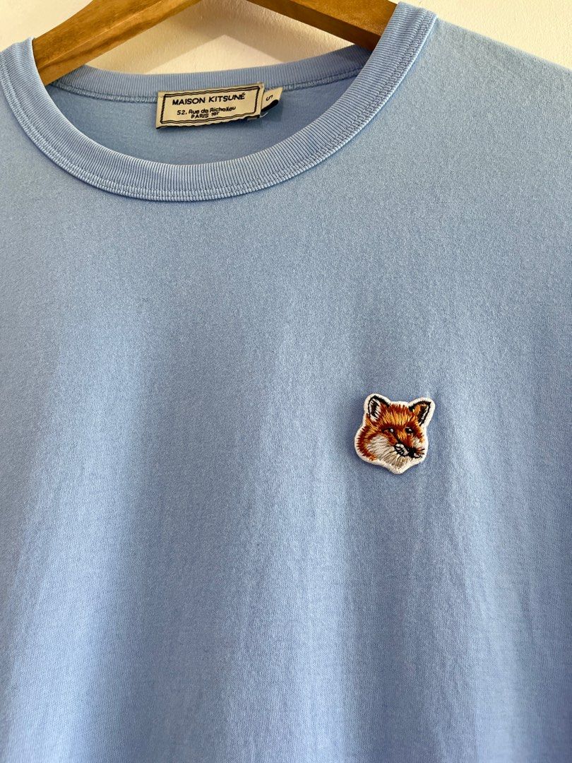 Maison Kitsune Fox Head Patch Tee (Light Blue) (Category: Luxury Apparel) located in Dasmarinas. Submitted by bandananowheree (Listing ID 1369608155, Image 2). Description: A classic t-shirt from Maison Kitsune, with a round ribbed welt collar and reinforced seams around the sleeves and waistband. The t-shirt features an embroidered fox head badge on the left chest, a signature of the Maison Kitsune brand. A great staple piece from the Parisian b