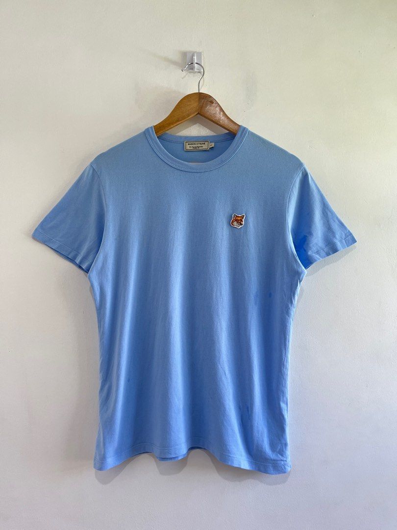 Maison Kitsune Fox Head Patch Tee (Light Blue) (Category: Luxury Apparel) located in Dasmarinas. Submitted by bandananowheree (Listing ID 1369608155, Image 1). Description: A classic t-shirt from Maison Kitsune, with a round ribbed welt collar and reinforced seams around the sleeves and waistband. The t-shirt features an embroidered fox head badge on the left chest, a signature of the Maison Kitsune brand. A great staple piece from the Parisian b