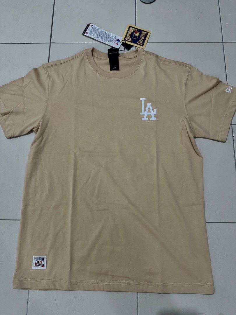 New era tee (Category: Tshirts & Polo Shirts) located in Singapore. Submitted by tamagotchi (Listing ID 1369628362, Image 1). Description: Both is L size for around 170-175cm. Item for $45 each Both for 80$ Ref link For blue color https://neweracap.com.sg/products/ss-tee-5950-pack-planetary-houastco-grph For brown color https://neweracap.com.sg/products/59fifty-pack-seaglass-los-angeles-dodgers-cooperstown-oat-milk-short-sleeve-t-shirt.