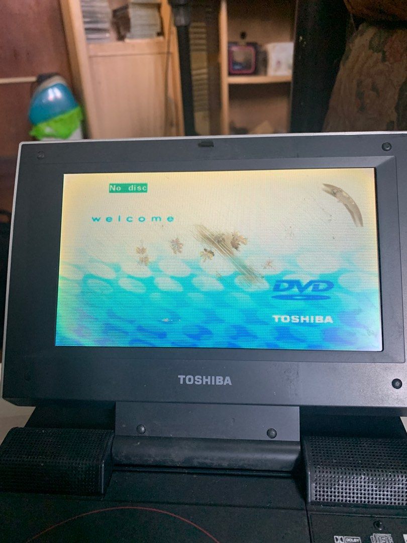 TOSHIBA PORTABLE DVD PLAYER (defective) (Category: Blu-Ray & Media Players) located in Valenzuela. Submitted by moonlightperks (Listing ID 1369549180, Image 2). Description: Unit comes with rechargeable battery, original charger and bag. CONDITION - Rechargeable battery is tested and working - Unit turns on when connected to power source ISSUES - has display but cannot read disc - LCD screen has scratches and black smudges (inside the surface, tr