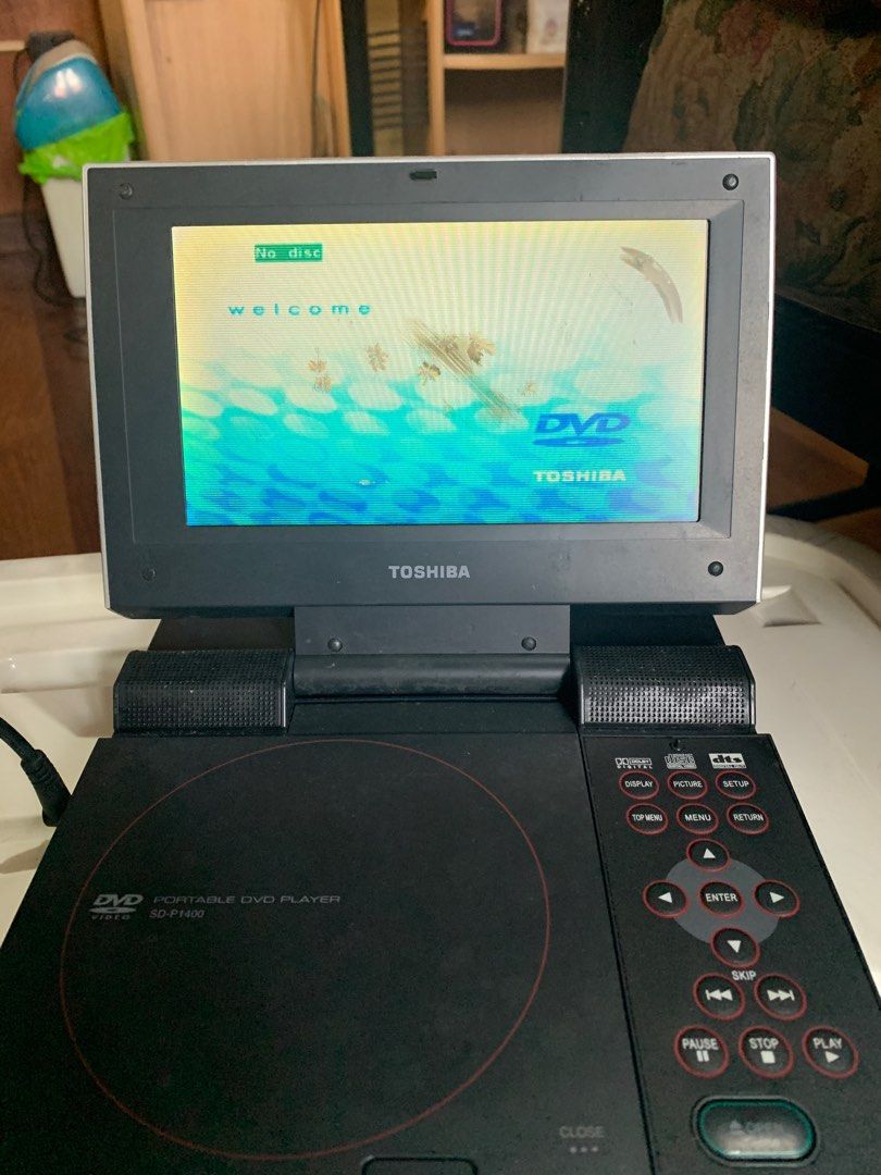 TOSHIBA PORTABLE DVD PLAYER (defective) (Category: Blu-Ray & Media Players) located in Valenzuela. Submitted by moonlightperks (Listing ID 1369549180, Image 1). Description: Unit comes with rechargeable battery, original charger and bag. CONDITION - Rechargeable battery is tested and working - Unit turns on when connected to power source ISSUES - has display but cannot read disc - LCD screen has scratches and black smudges (inside the surface, tr