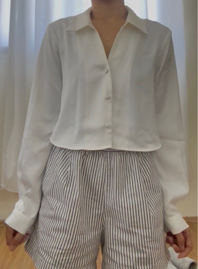 Zara Satin Button Down Crop Top in White (Category: Blouses) located in Mandaluyong City. Submitted by trishi.trish (Listing ID 1369552335, Image 2). Description: - In great condition - Material is super soft and thick - Original price was 1995 I’m 5ft 3”, 32” bust and usually a size XS-S. Sizes when laid flat: - 18” bust - 17” length - 7” sleeve width - 23” sleeve length RFS: Decluttering.