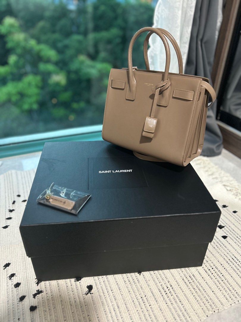 SAC DE JOUR IN SMOOTH LEATHER Small in Taupe (Category: Bags & Wallets) located in Singapore. Submitted by kgo49 (Listing ID 1327919074, Image 1). Description: Brand new like SAC DE JOUR IN SMOOTH LEATHER Purchased in Nov 2022 Used only 5-8 times Tiny scratch - from the strap chain Negotiable Box included Pick up at River Valley or Great World Need the money to buy school laptop .