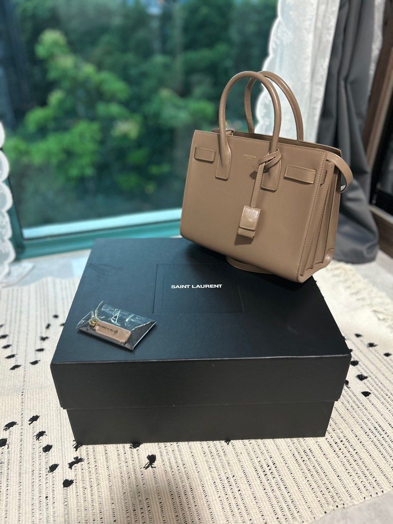 SAC DE JOUR IN SMOOTH LEATHER Small in Taupe (Category: Bags & Wallets) located in Singapore. Submitted by kgo49 (Listing ID 1327919074, Image 3). Description: Brand new like SAC DE JOUR IN SMOOTH LEATHER Purchased in Nov 2022 Used only 5-8 times Tiny scratch - from the strap chain Negotiable Box included Pick up at River Valley or Great World Need the money to buy school laptop .