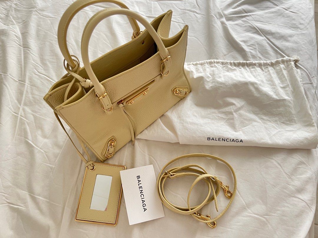 Balenciaga A4 Papier Tote Bag (Category: Luxury Bags & Wallets) located in Santa Cruz. Submitted by beautsbees (Listing ID 1366896173, Image 2). Description: Light Yellow. Gold Hardware. Comes with strap, dustbag, card and mirror. Very functional bag. Fits a lot of stuff. Can be worn as top handle or crossbody. Same size as Louis Vuitton On the Go BB. In excellent condition. With unnoticeable flaws. .