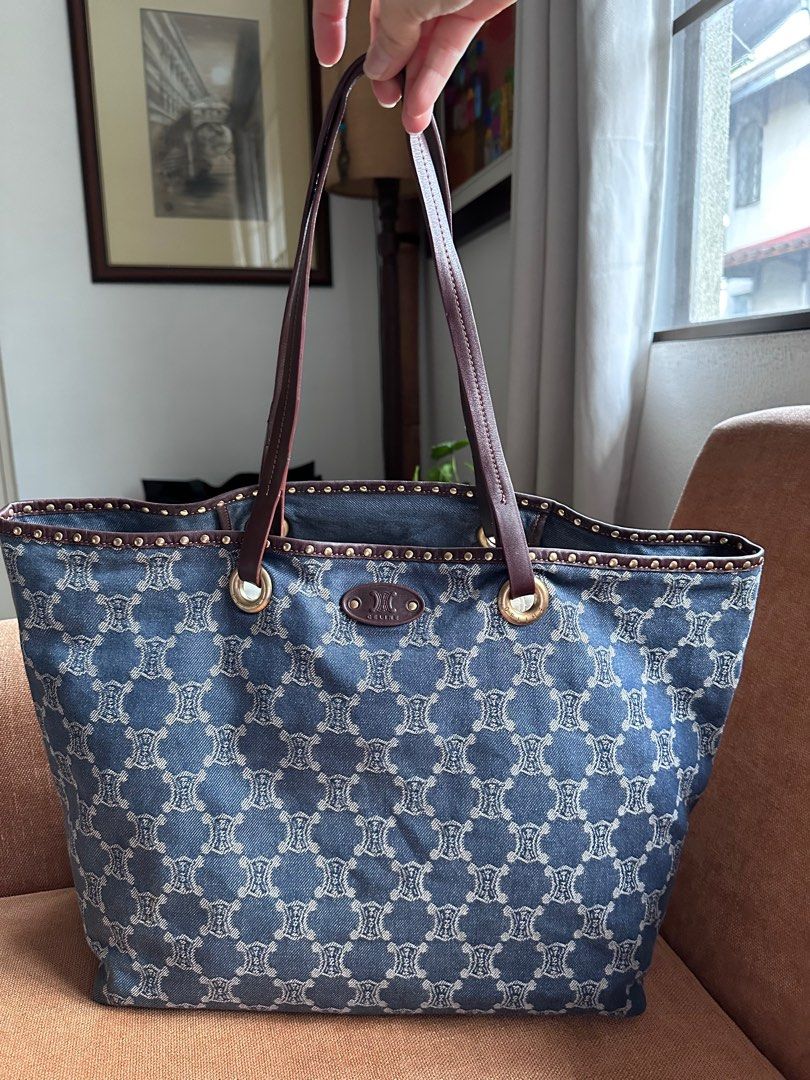 Denim Tote Bag (Category: Luxury Bags & Wallets) located in San Juan City. Submitted by jaziman20249087 (Listing ID 1366825531, Image 1). Description: Authentic Celine Macadam Denim Tote Bag only with Legitgrails certificate of authenticity Denim logo monogram body Flat leather handles Open top Interior zip pocket. Studded leather trim/piping Very spacious Dimensions (please refer to photo) Height 12.5 inches Top width 18 inches Base width 13.5 i