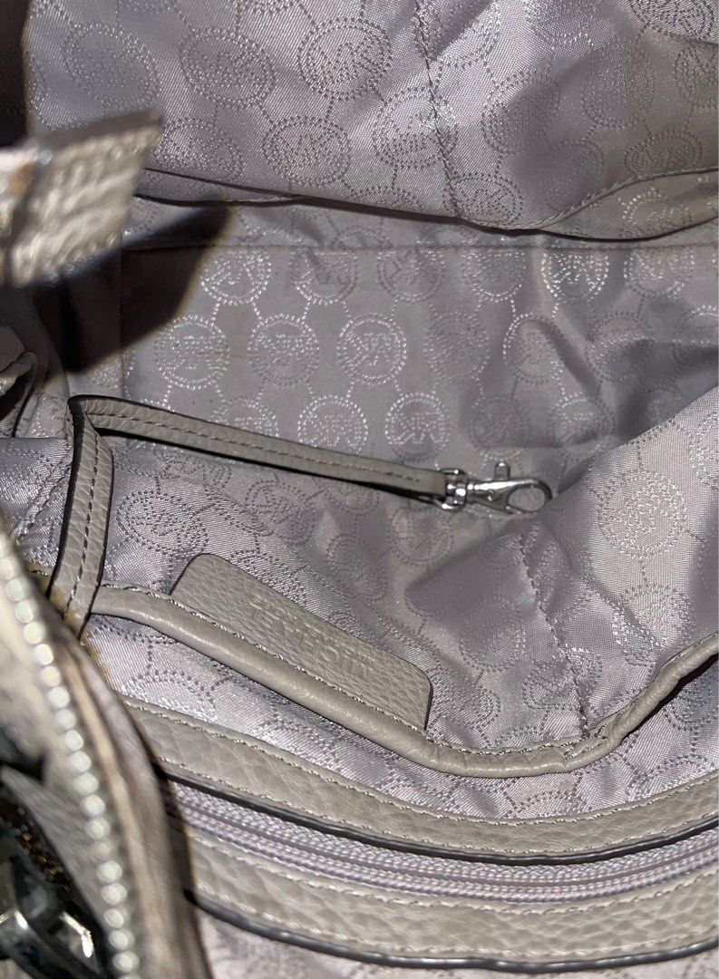 Michael Kors Gray Crossbody / Hand Bag (Category: Luxury Bags & Wallets) located in Paranaque City. Submitted by lois.ng (Listing ID 1366748463, Image 3). Description: Authentic Unnoticeable stains near metal buckles No other issues Pm for more details.