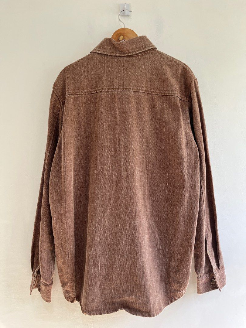 NANUSHKA Oversized Dome Denim Shirt (Category: Luxury Apparel) located in Dasmarinas. Submitted by bandananowheree (Listing ID 1366762127, Image 3). Description: Long sleeve non-stretch linen denim shirt in brown. Fading throughout. Buttoned spread collar. Button closure at front. Grained faux-leather patch pocket at chest. Shirttail hem. Two-button barrel cuffs. Tortoiseshell hardware..