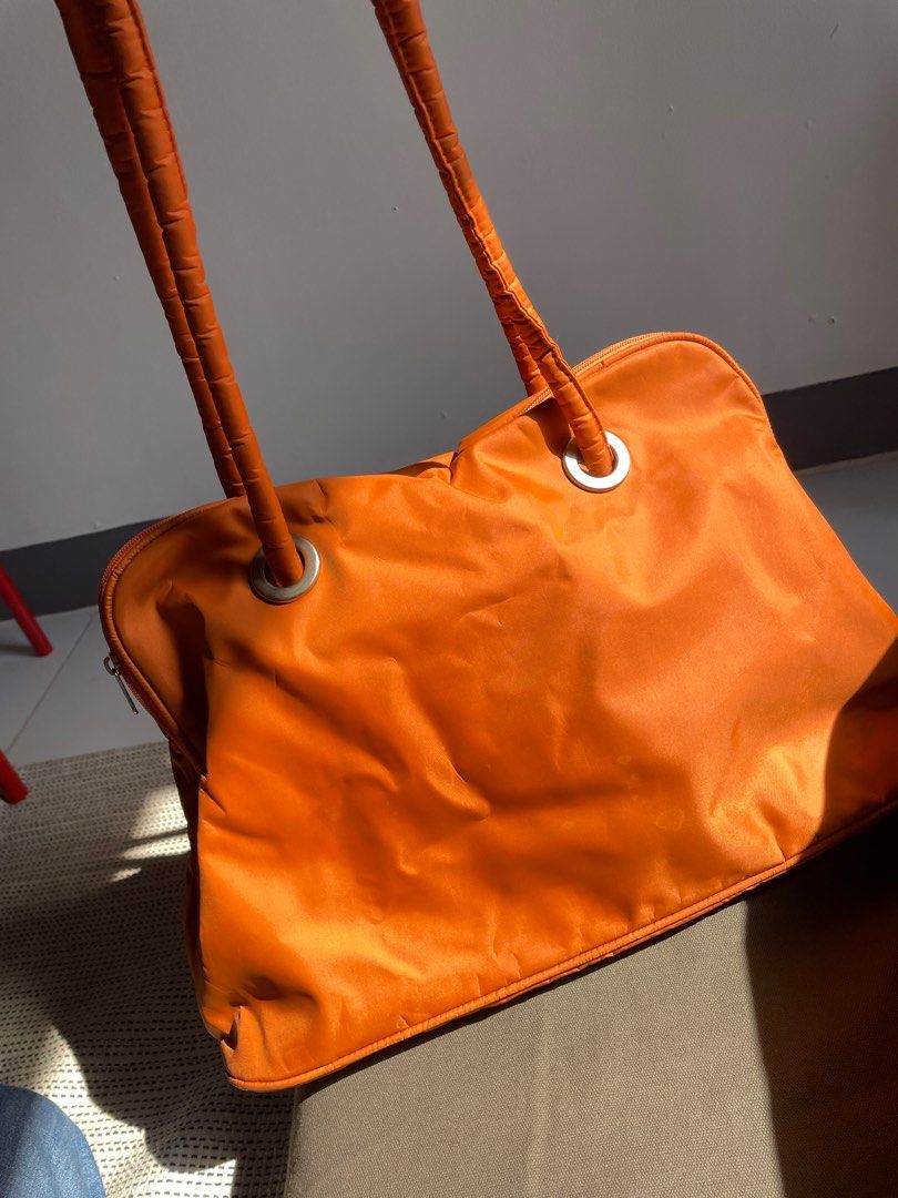 Orange Puffy Shoulder Bag (no brand) (Category: Shoulder Bags) located in Quezon City. Submitted by decluttering.neyns (Listing ID 1366789317, Image 3). Description: For pick-up: - Maginhawa QC - Buyer to shoulder and process the booking if pick up via grab/lalamove - Payment before delivery For delivery: - J&T (M,T,Th and Fr) - Payment first before delivery. - Buyer to shoulder courier fee.