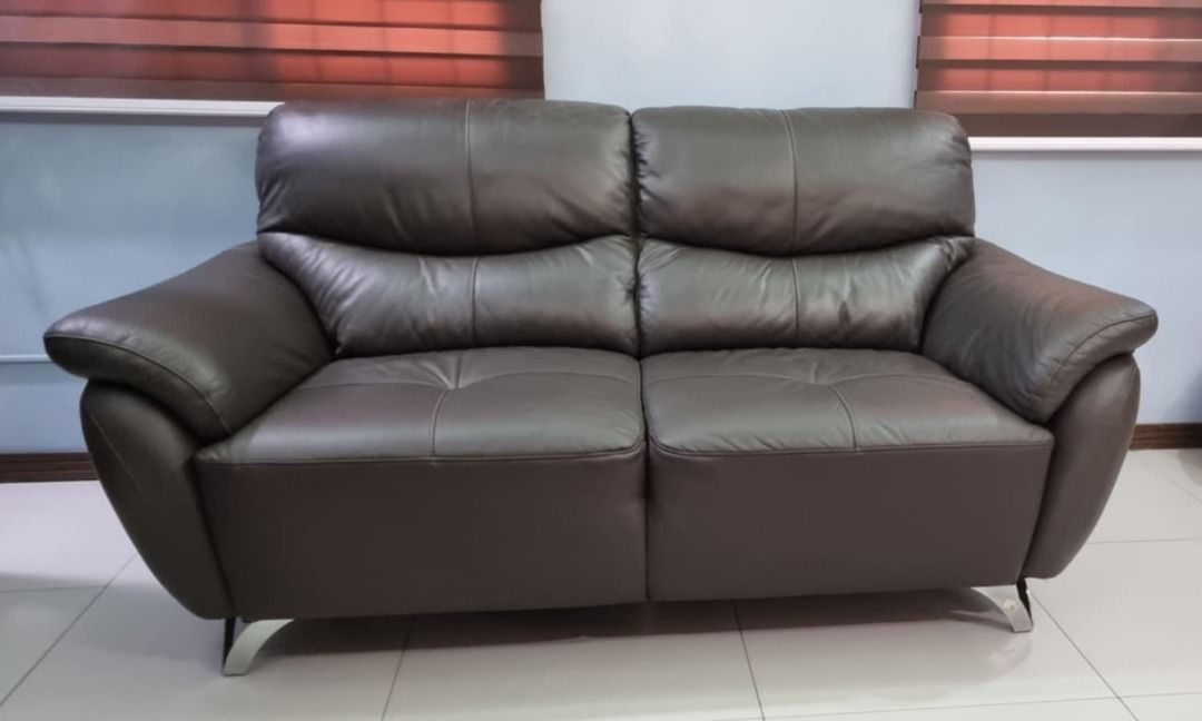 Wide 2-seater leather sofa (Category: Sofas) located in Paranaque City. Submitted by mom.may8ski (Listing ID 1366818915, Image 2). Description: 2-seater brown sofa purchased from Blims Fine Furniture (bought at 42k). Natural leather seats, back and armrests. Hidden parts made of artificial leather. Seats are wide so it can actually fit 3 people.