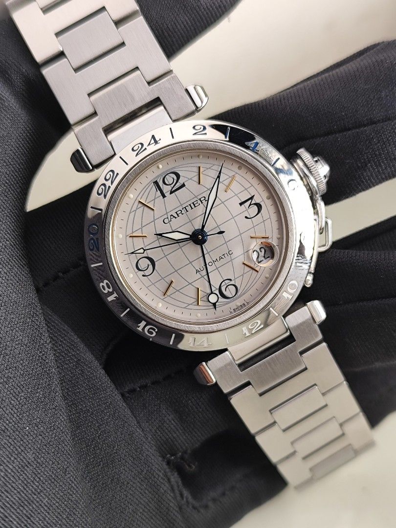 Cartier Pasha GMT (Category: Luxury Watches) located in San Juan City. Submitted by MW_888 (Listing ID 1370401866, Image 2). Description: Cartier Pasha GMT 35mm Silver globe dial Automatic Ref 2377 9/10 condition Inclusions: watch, original bracelet fit to approx 6.8" wrist, Cartier AM box and watch case *watch is verified on Cartier Care website *photo reference on 6.5" wrist 135k.