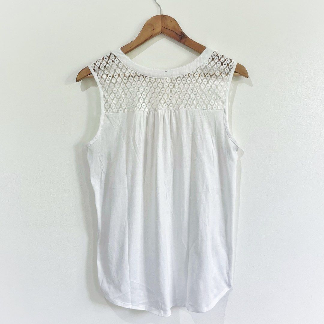 PerSeption Concept white lace tank top split neckline with buttons (Category: Sleeveless) located in Quezon City. Submitted by HannoCollection (Listing ID 1370270515, Image 2). Description: Brand: PerSeption Concept (made in Vietnam) Size: L on tag ✔️ ACTUAL PHOTOS POSTED ✔️ COD Available (with additional 15% fee) ✔️ MOP: GCash or Landbank, ꜱʜᴏᴘᴇᴇ checkout (SCO for delivery) ✔️ same day delivery within MM available.