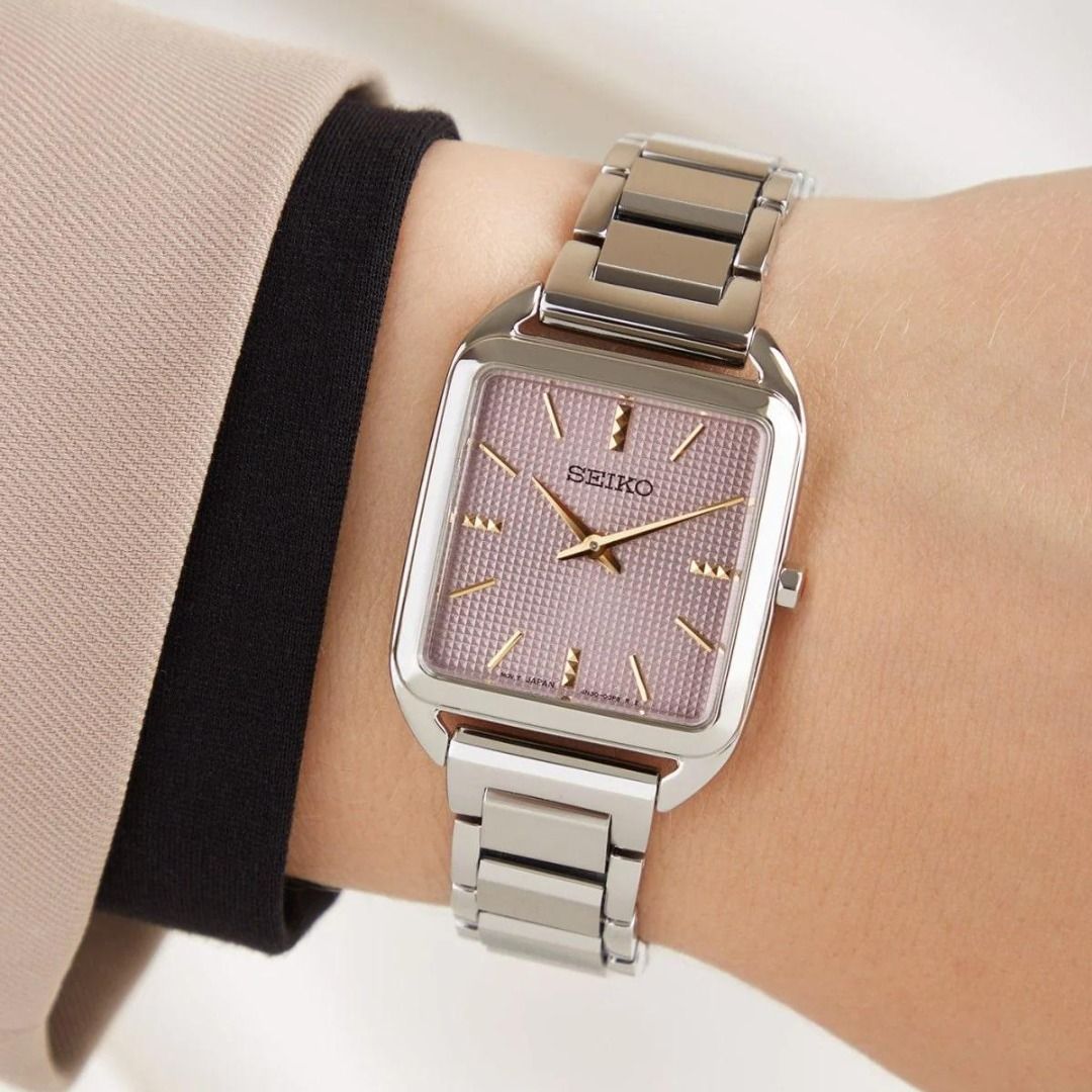 Seiko SWR077P1 Essentials Mauve Pink Grid Pattern Dial Analog Stainless Steel Ladies Dress Watch SWR077 (Category: Women's Watches) located in Singapore. Submitted by kbvkbv (Listing ID 1370595972, Image 2). Description: Watch Information Movement Type : Quartz Precision : ±15 seconds per month Case Size Thickness:6.4mm Diameter:26.0mm Lug-to-lug:34.8mm Crystal : Hardlex Clasp : Three-fold clasp with push button release Distance between lugs : 15