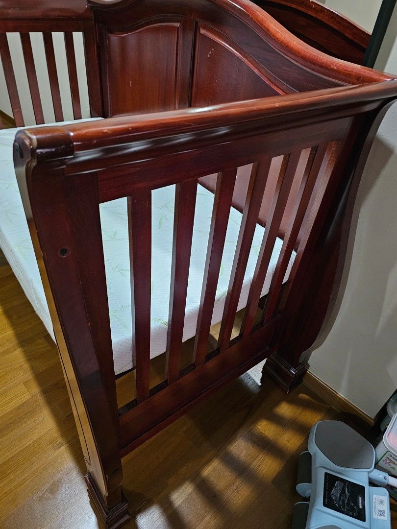 Solid wood cot (Category: Cots & Cribs) located in Singapore. Submitted by cindyding (Listing ID 1370486986, Image 2). Description: This is a very solid cot that have serve us trustedly over the last 10 years. mattress has been newly purchase recently. this cot could be transform from cot to a baby bed or day bed. comes with another wood barrier that is removable. it's still in a very good condition, hopefully it goes to a home that requires it..