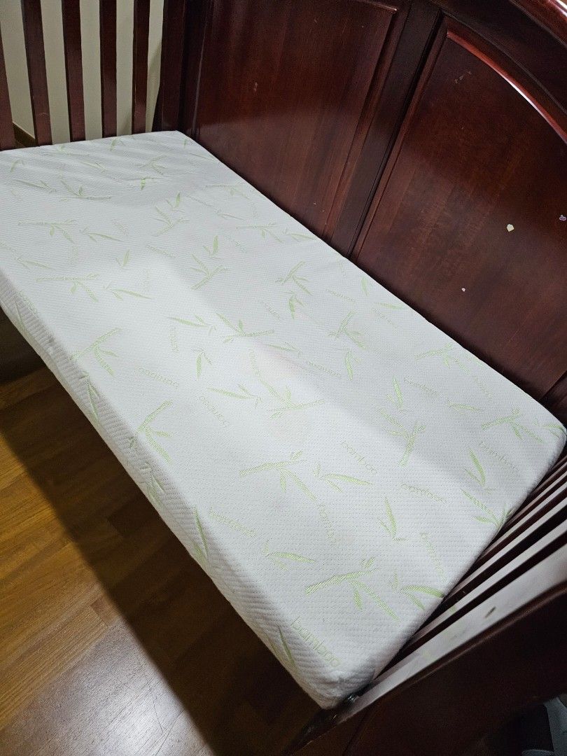 Solid wood cot (Category: Cots & Cribs) located in Singapore. Submitted by cindyding (Listing ID 1370486986, Image 3). Description: This is a very solid cot that have serve us trustedly over the last 10 years. mattress has been newly purchase recently. this cot could be transform from cot to a baby bed or day bed. comes with another wood barrier that is removable. it's still in a very good condition, hopefully it goes to a home that requires it..