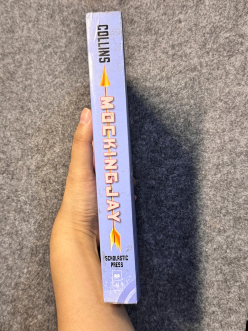 The Hunger Games: Mockingjay (Paperback) (Category: Storybooks) located in Caloocan City. Submitted by thenookofeli (Listing ID 1370603011, Image 2). Description: Hunger Games: Mockingjay by Suzanne Collins Condition: Lightly Used - Paperback - Foxing edges - The cover is slightly torn - Tanned pages but all intact RFS: Extra Copy.