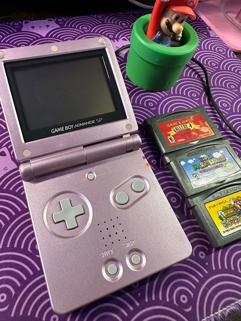 Gameboy Advance SP AGS-001 Pearl Pink Bundle (Category: Nintendo) located in Paranaque City. Submitted by kamiruizu.clutter (Listing ID 1370670611, Image 2). Description: GAMEBOY ADVANCE SP AGS-001 PEARL PINK 4000php inclusions: -GB SP AGS-001 unit (non-ips, front lit screen) (Condition: Visible signs of usage, scratches and dust beneath screen. Overall working and charging. Volume is decent. Screen light is working. Buttons clicky and responsive