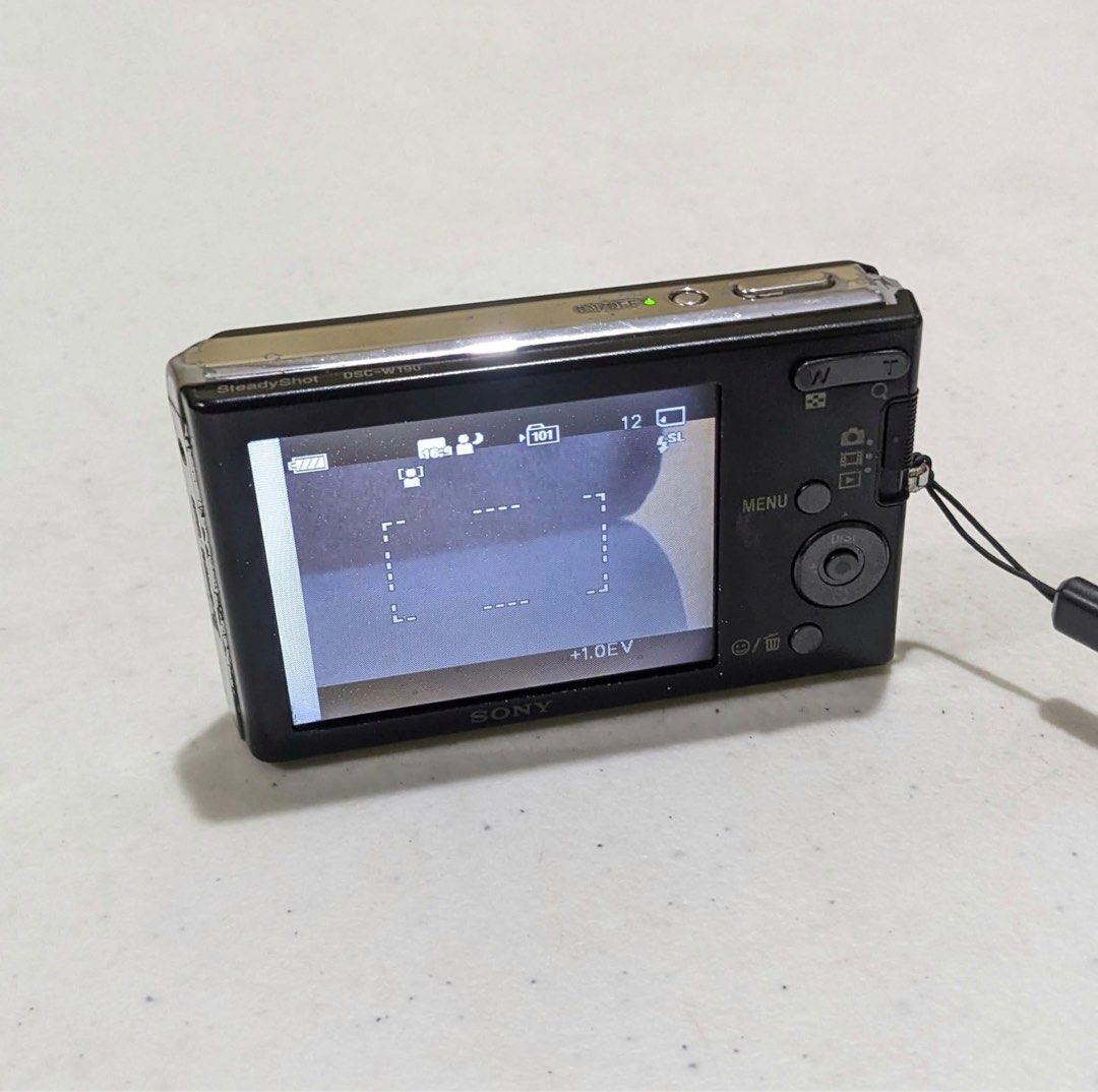 Sony Cybershot DSC W190 Digital Camera (Digicam) (Category: Cameras) located in Pasig City. Submitted by _mathilda (Listing ID 1370781043, Image 2). Description: 📸 Sony Cybershot DSC W190 — 12.1 Mega Pixels — 3x Optical Zoom — Image Stabilization — ISO: 100-3200 — Body Condition: 6/10 — LCD issue, signs of usage, and small spot on lens — Crisp photo quality — Fully functional (all buttons + flash working) — Shooting Modes: • Auto, Program, Scene