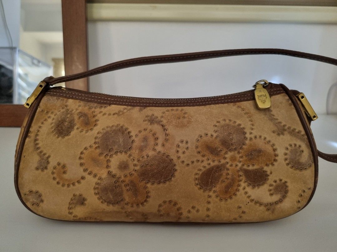 MCM Vintage Leather Hand Tooled Shoulder Bag (Category: Luxury Bags & Wallets) located in Muntinlupa City. Submitted by hcasi (Listing ID 1370978113, Image 3). Description: MCM Vintage Leather Hand Tooled Shoulder Bag Rubs on lining Tarnishing on hardware Minimal dirt inside 2 pockets inside Zipper working properly No cracks on strap Can fit a lot inside Needs bag spa MOP: GCash/Maya/BPI SF: Grab/Lalamove/J&T.