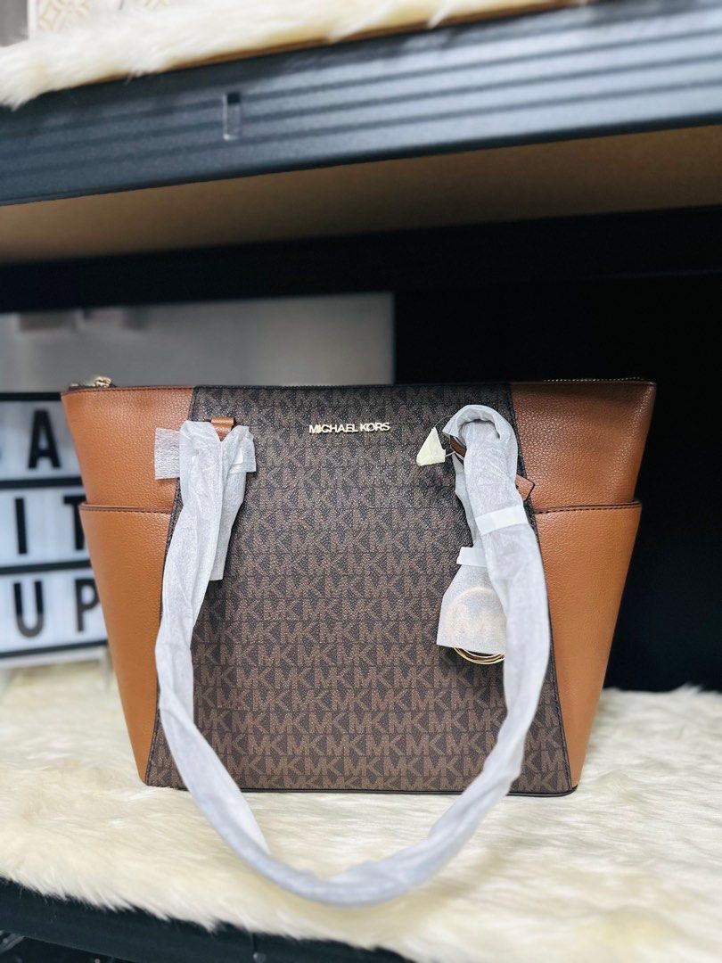 Michael Kors Charlotte Tote Bag (Category: Luxury Bags & Wallets) located in Porac. Submitted by bagitupshopph (Listing ID 1370983482, Image 1). Description: 💯 Authentic from 🇺🇸 Michael Kors Charlotte Tote Bag Brow Monogram Canvas Very roomy .