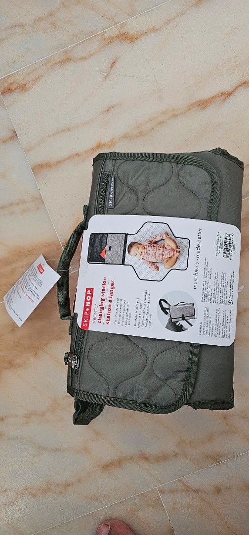 Pronto Signature Diaper Changing Station - Sage (Category: Changing Mats & Accessories) located in Singapore. Submitted by misohappi (Listing ID 1371005723, Image 2). Description: The ultimate diaper changing pad makes baby changing a breeze—no matter where you are. Super-easy to unfold with one hand (leaving the other free to juggle baby & more), our ultra-convenient clutch features a wipe-clean, zip-off baby changing pad and translucent wipes c