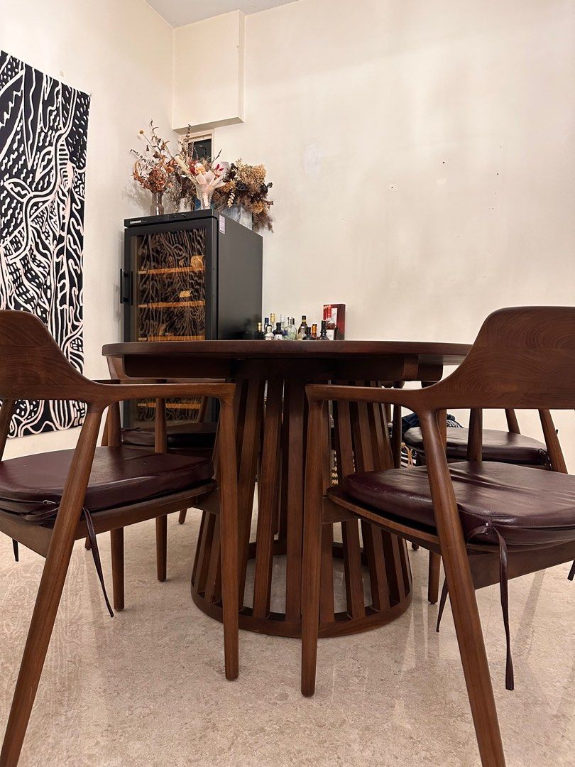 Dining set (Category: Tables & Sets) located in Singapore. Submitted by sapphfireee (Listing ID 1371303383, Image 2). Description: First photo is AI generated, inserting our table into a different interior design Custom made from Rooma in 2021 Table Diameter: 120CM Height: 76.5CM Some scratches and watermarks on the table, can be revarnished / repolished and will look brand new! 4 chairs included No defects on the chairs except the detachable lea
