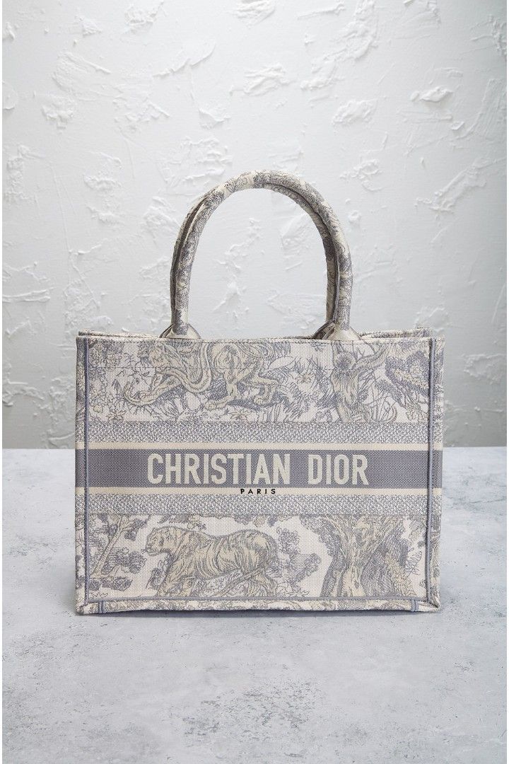 Dior Tote Bag Small (Category: Bags & Wallets) located in Singapore. Submitted by smurfingstars (Listing ID 1371336732, Image 1). Description: The Details • Unlined grey toile de jouy embroidered canvas with grey embroidered seams and edges • Made in Italy • Open top • One main compartment • Measures approx 36 cm W x 28 cm H x 14 cm D Top handle with a 15 cm drop Conditions: Mint Bag comes with Box, Dust Bag & Authentication Card. 100% Authentic 