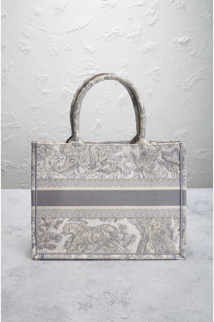 Dior Tote Bag Small (Category: Bags & Wallets) located in Singapore. Submitted by smurfingstars (Listing ID 1371336732, Image 2). Description: The Details • Unlined grey toile de jouy embroidered canvas with grey embroidered seams and edges • Made in Italy • Open top • One main compartment • Measures approx 36 cm W x 28 cm H x 14 cm D Top handle with a 15 cm drop Conditions: Mint Bag comes with Box, Dust Bag & Authentication Card. 100% Authentic 