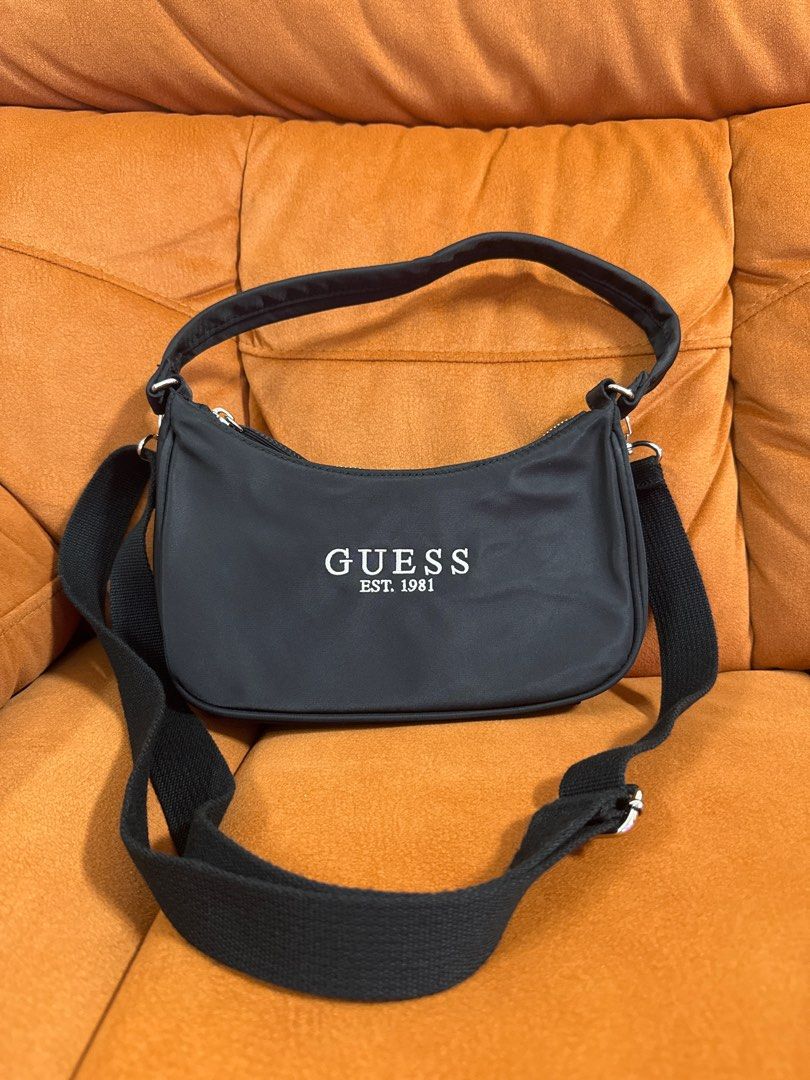 Authentic Guess ladies bag crossbody shoulder bag (Category: Bags & Wallets) located in Singapore. Submitted by cleartorebaitems (Listing ID 1371481150, Image 1). Description: Unused, no tags. Come with dust bag. Can be shoulder carried, or attach with a long sling for crossbody Selling due to impulse buy. 24cm L x 13cm H x 6cm B.