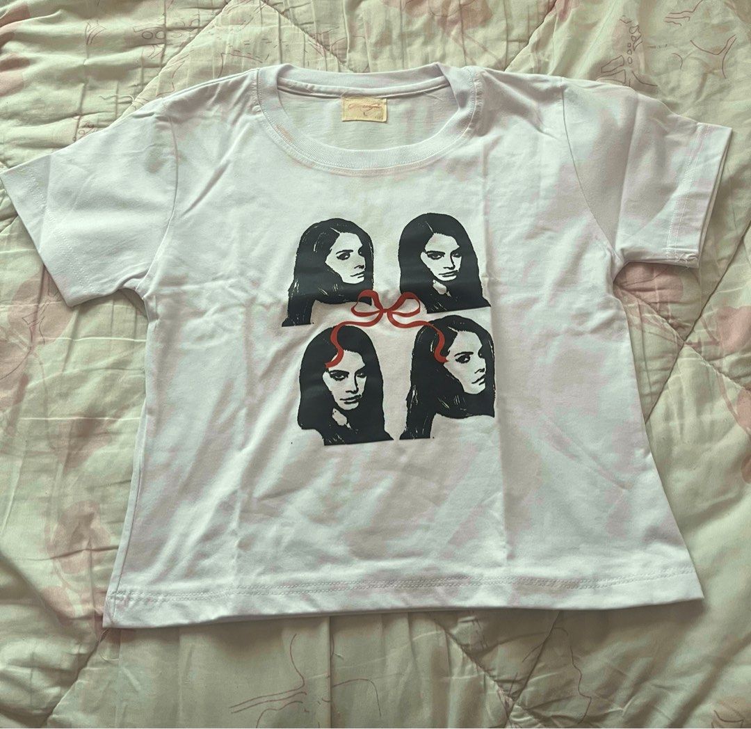 Lana Del Rey baby tee (Category: Shirts) located in Quezon City. Submitted by ferryrisse (Listing ID 1371610215, Image 2). Description: - bought from the orange app - M-L (keep in mind, this is a baby-tee) - rfs: wrong size.