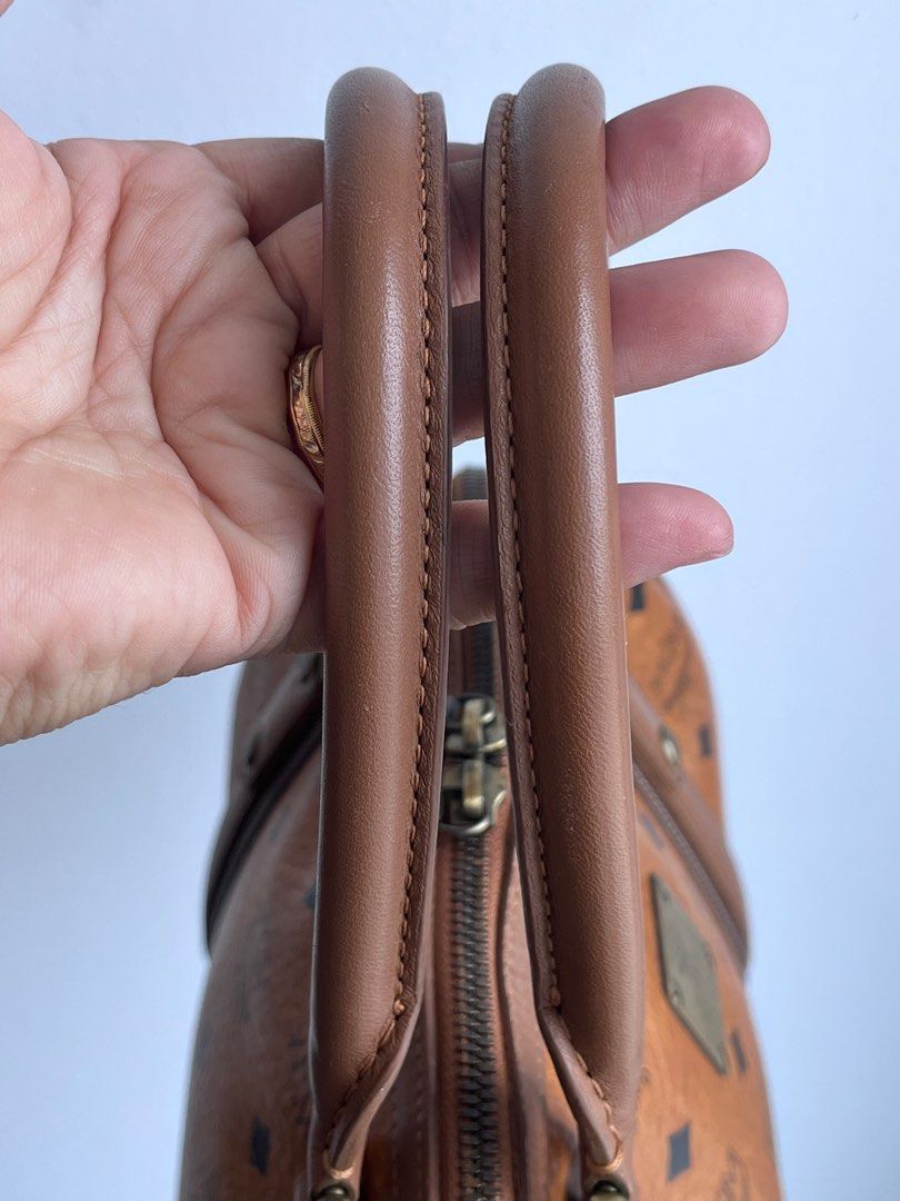 MCM Visetos Alma Cognac Boston Bag (Category: Luxury Bags & Wallets) located in Taguig. Submitted by mhalet.902 (Listing ID 1371624742, Image 3). Description: Gender: Ladies’ Material: Coated canvas Stamp: 1011077020122 Interior: One zip pocket and two open pockets Measurements: 11.6”L X 5.25”W X 7”H Handle Drop: 4.75” Hardware: Gold tone Inclusions: Luxe In dust bag Detailed Item Description: The item has scuff marks and discoloration on the pip