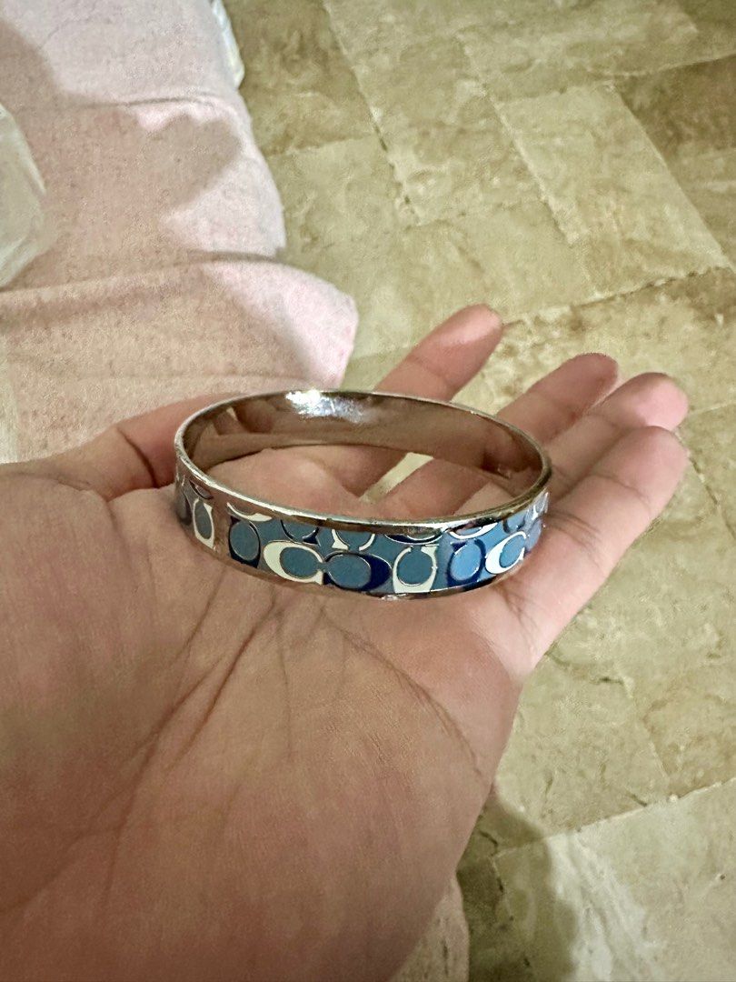 🚨 Coach Enamel Blue Bracelet🚨 (Category: Bracelets) located in Quezon City. Submitted by _apparels_ (Listing ID 1371869211, Image 1). Description: 💙 FOR SALE: Authentic Coach Enamel Blue Bangle 💙 ✨ Chic, timeless, and perfect for everyday elegance! ✔️ Authentic Coach ✔️ Enamel finish in classy blue ✔️ Good wearable condition ⚠️ Minor hairline scratches (not noticeable when worn) 📏 Approx. 2–2.5” diameter (fits most wrists) 💸 PHP 1000 only —