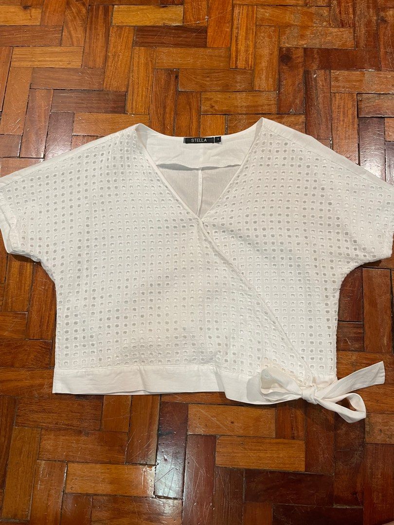 White Eyelet Wrap Top (Category: Blouses) located in Quezon City. Submitted by mnl.declutter (Listing ID 1371764506, Image 1). Description: White Eyelet Wrap Top •in great condition •used once only •eyelet part not see through •bought in department store Size guide •width ≈ 19.5 in •length ≈ 18 in •sleeve length ≈ 10.5 in DM for any questions or inquiries! 😊 MOP - Gcash SF - c/o buyer.