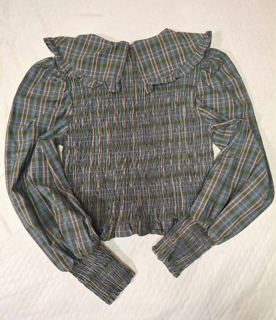 Zara Checkered Pattern Frill Collar Blouse (Category: Blouses) located in Makati City. Submitted by sweetsj (Listing ID 1371854561, Image 1). Description: It features a ruffled collar, long sleeves with smocked cuffs, and a smocked bodice 10/10 condition. Size Small but fits up to medium Width: 14” but stretchable Length: 16”.