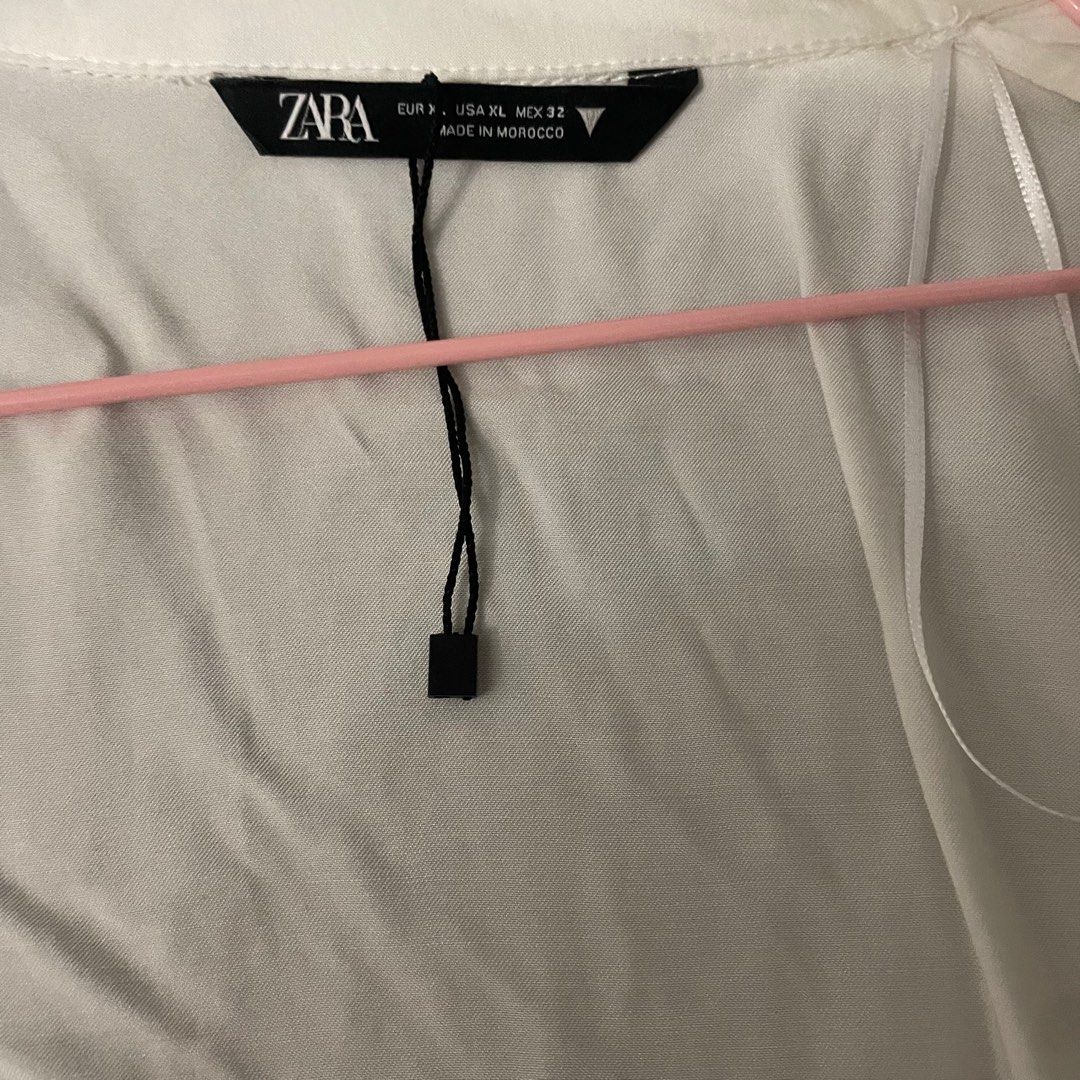 Zara white tie top (Category: Blouses) located in Quezon City. Submitted by andreasclothes (Listing ID 1371842101, Image 2). Description: New but price tag removed. V flattering.